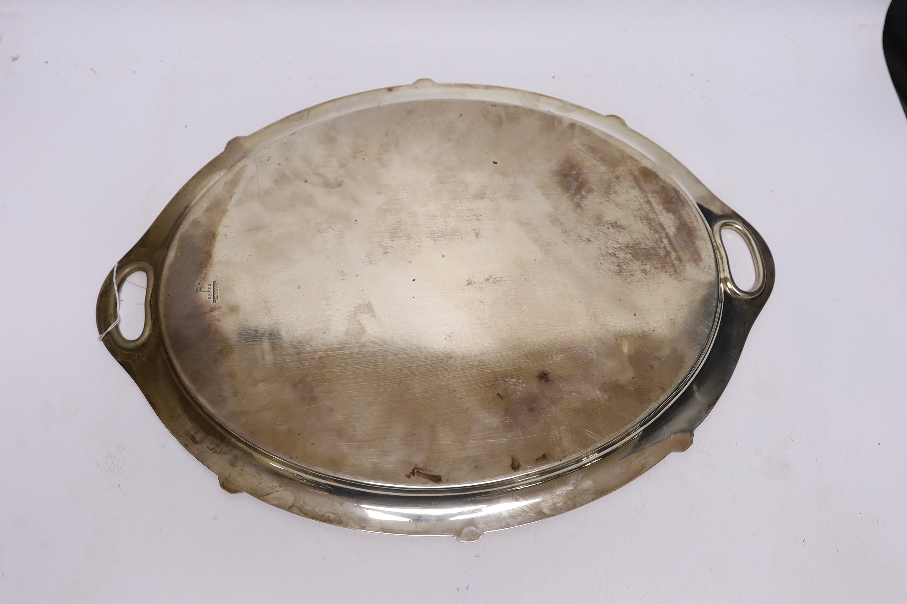 A George V silver oval presentation tea tray, with inset handles, Walker & Hall, Sheffield, 1935, 49.4cm, 54.2oz.